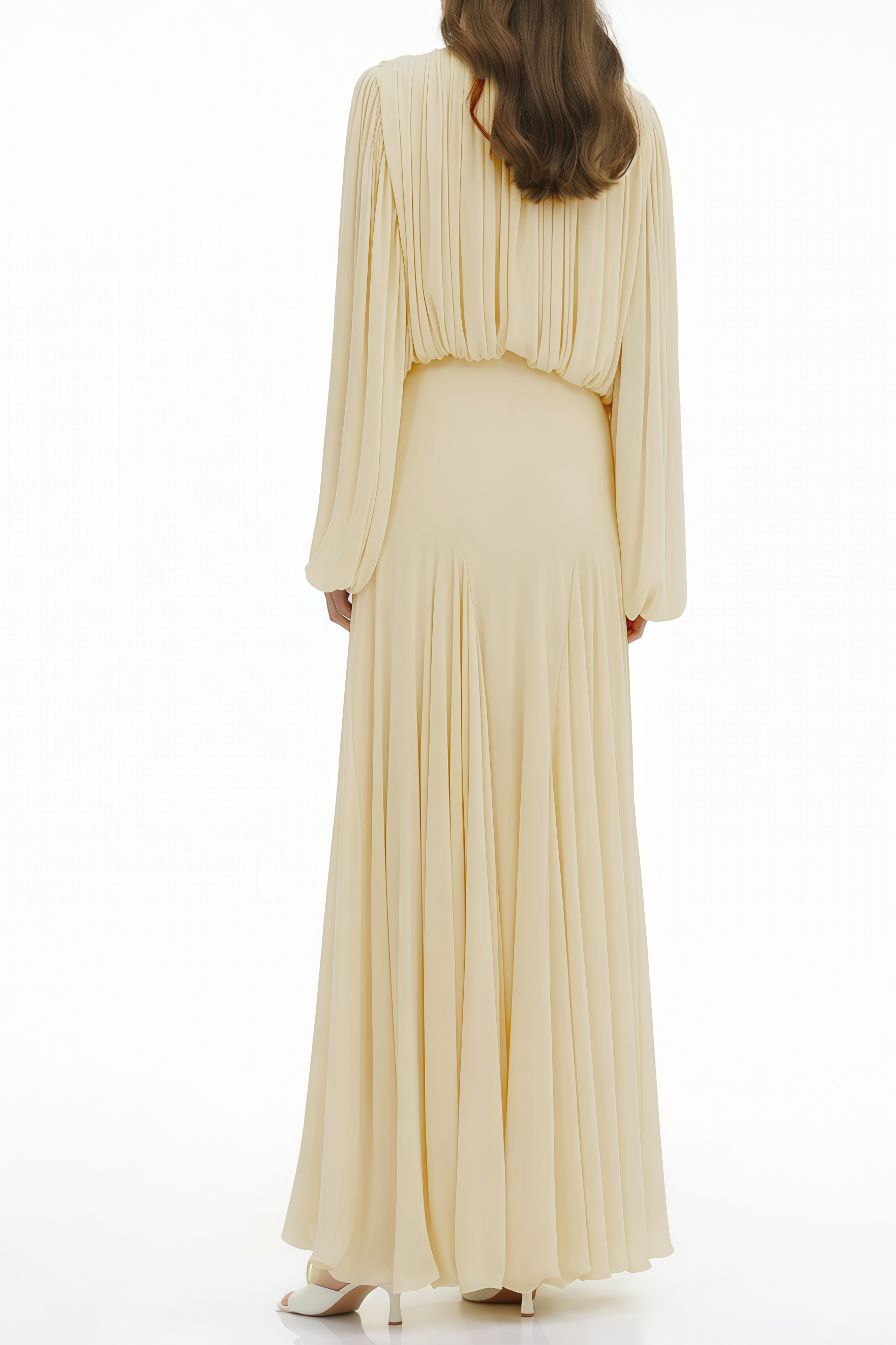 Pale yellow maxi dress with a ruched bodice, high round neckline, and long bishop sleeves
