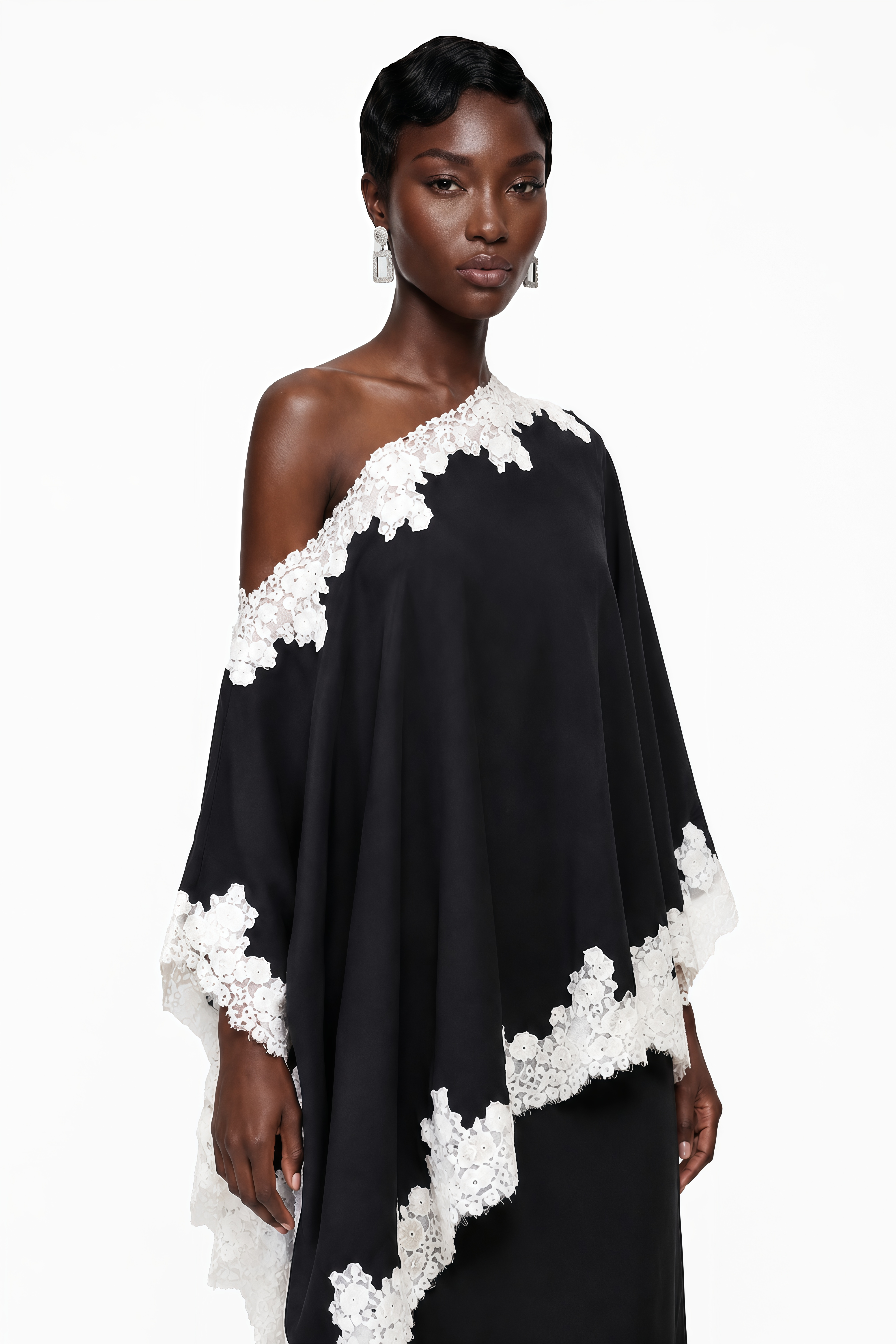 Black one-shoulder maxi dress with an asymmetric lace-trimmed cape and lace-trimmed hem