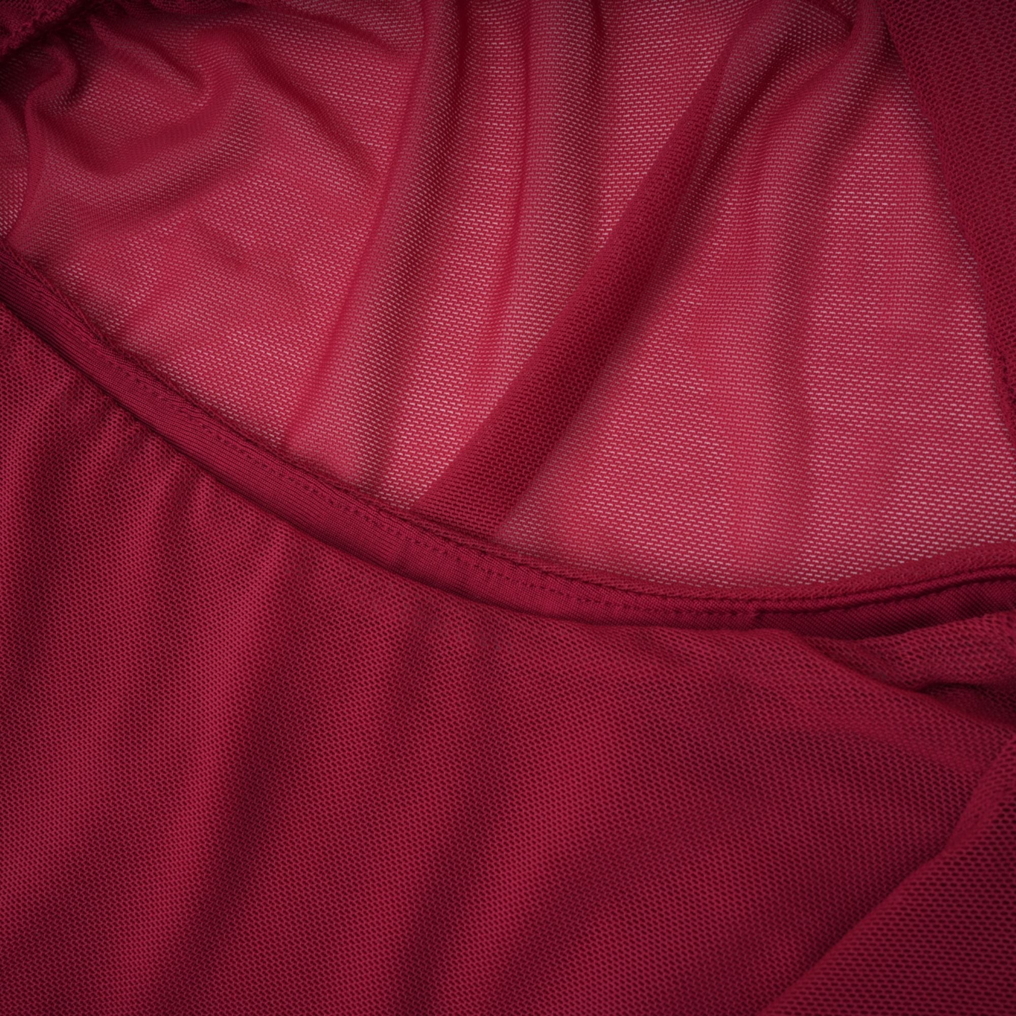 Burgundy ruched gown with a draped high neckline and sheer skirt