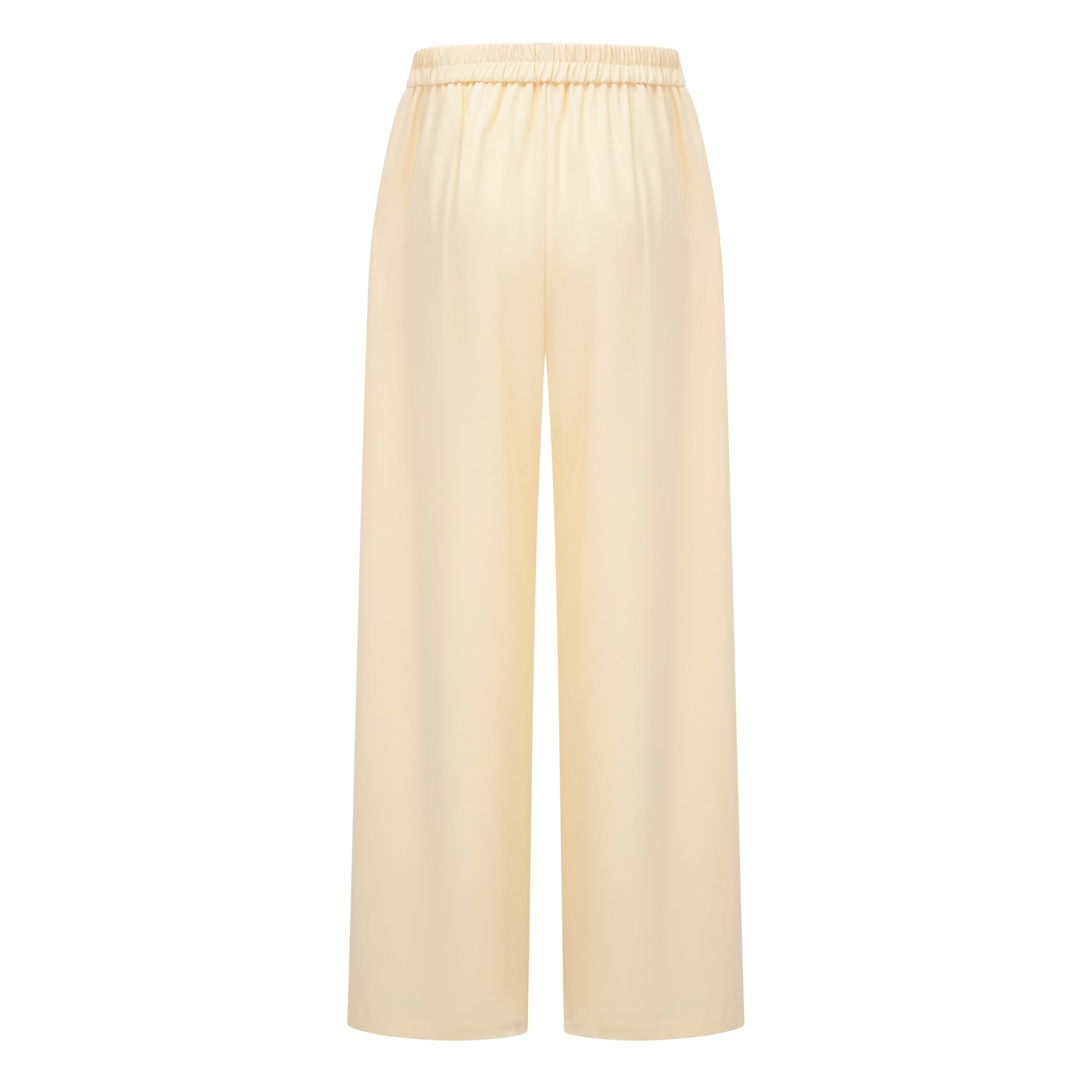 Pale yellow top and trousers set with an asymmetric blazer bodice, draped sheer neckline, and cape panels