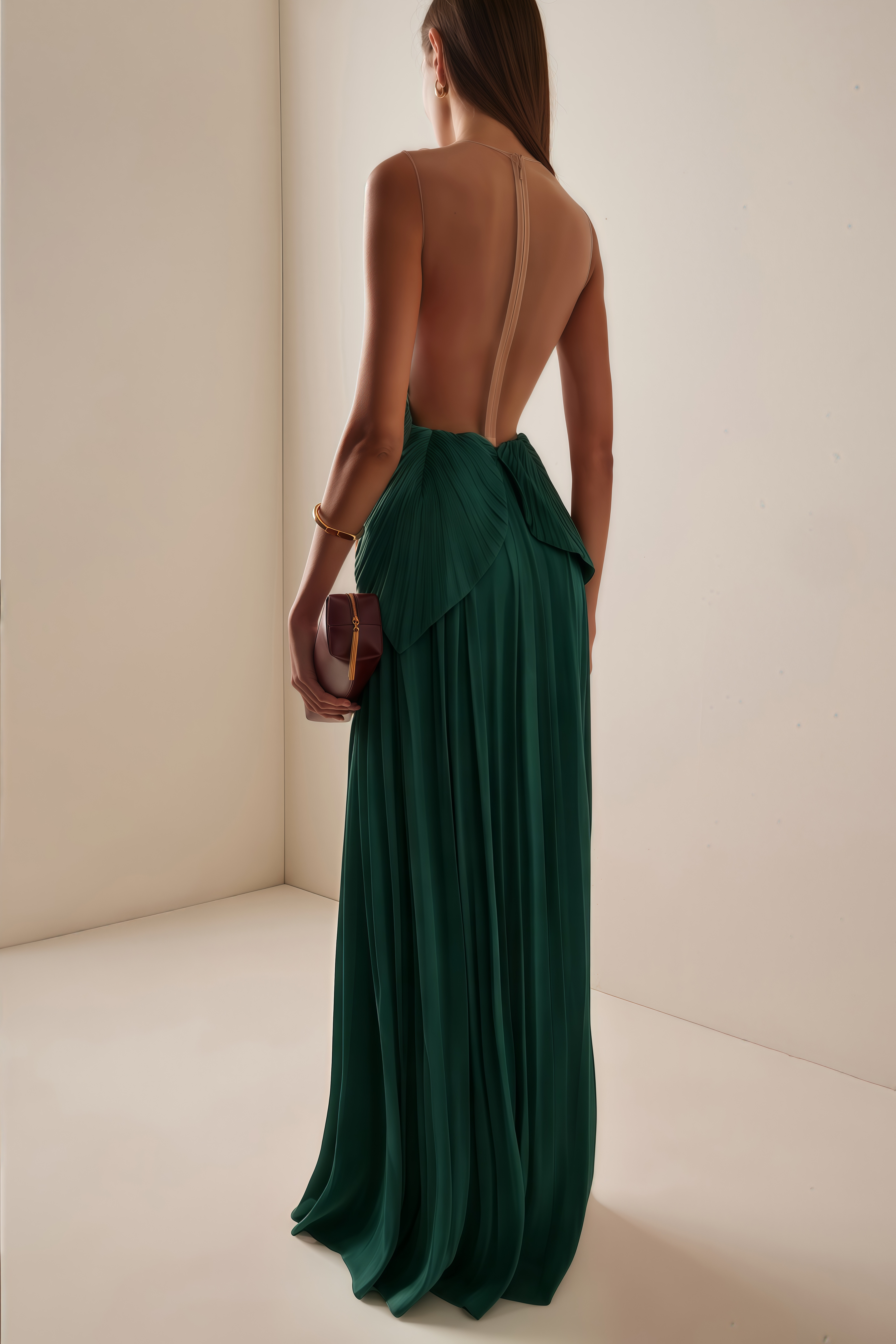 Emerald green pleated maxi dress featuring a structured geometric bodice with a sheer mesh illusion neckline