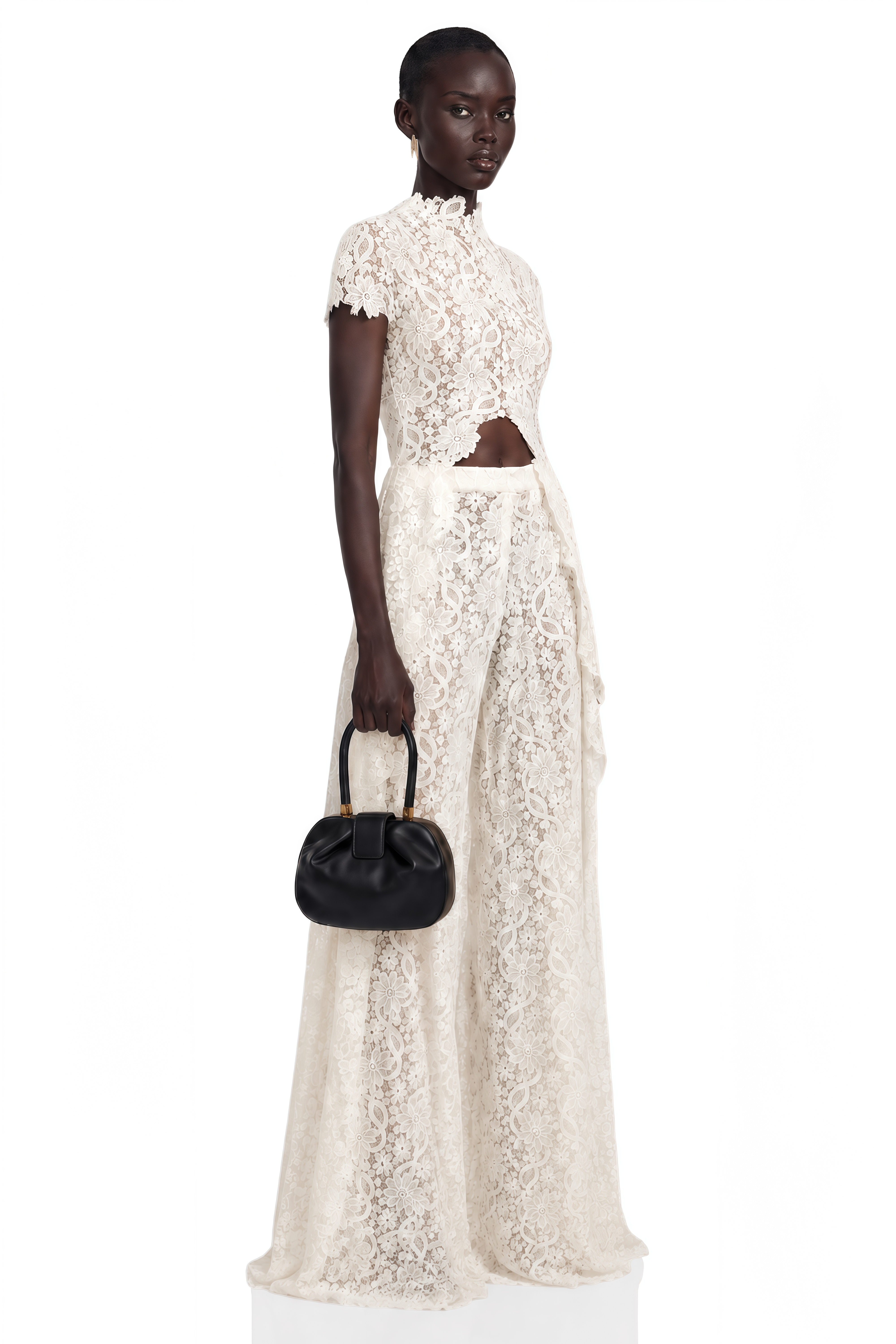 Black long-sleeve maxi dress with a sheer lace bodice and a draped skirt