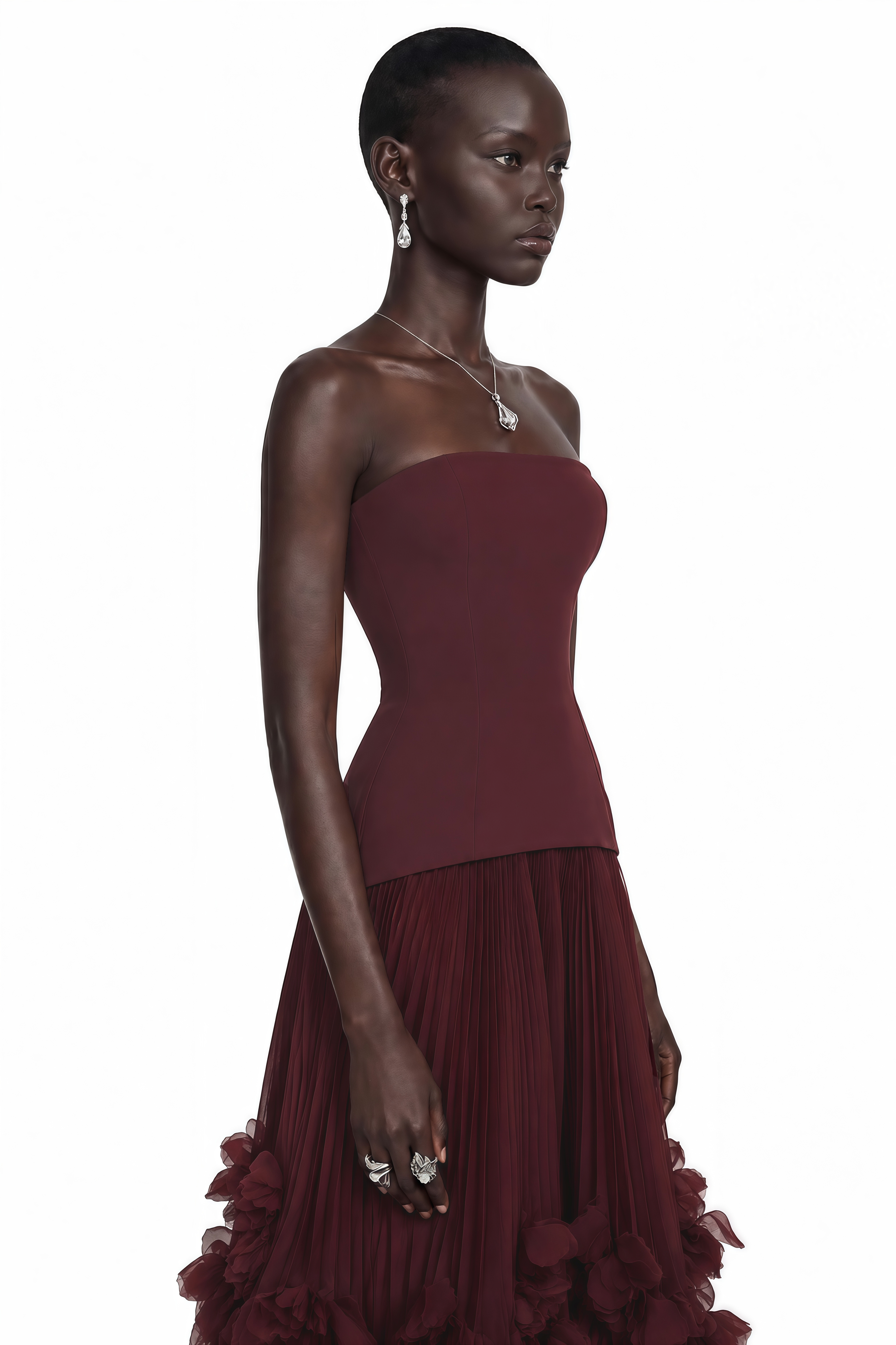 Burgundy strapless maxi dress with a drop-waist bodice and pleated tulle skirt featuring a ruffled hem