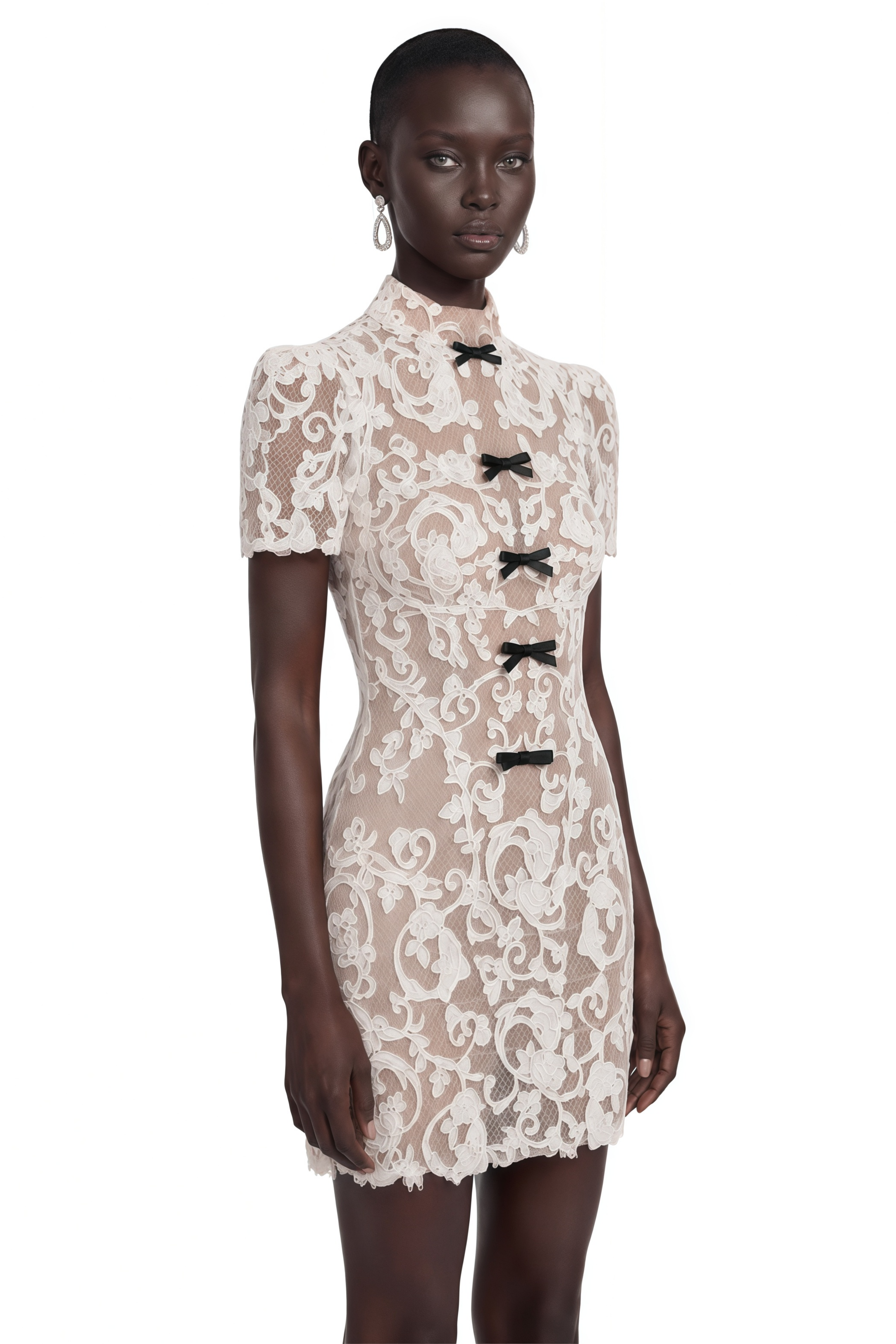 Cream lace high-neck mini dress with short sleeves and front black bow details