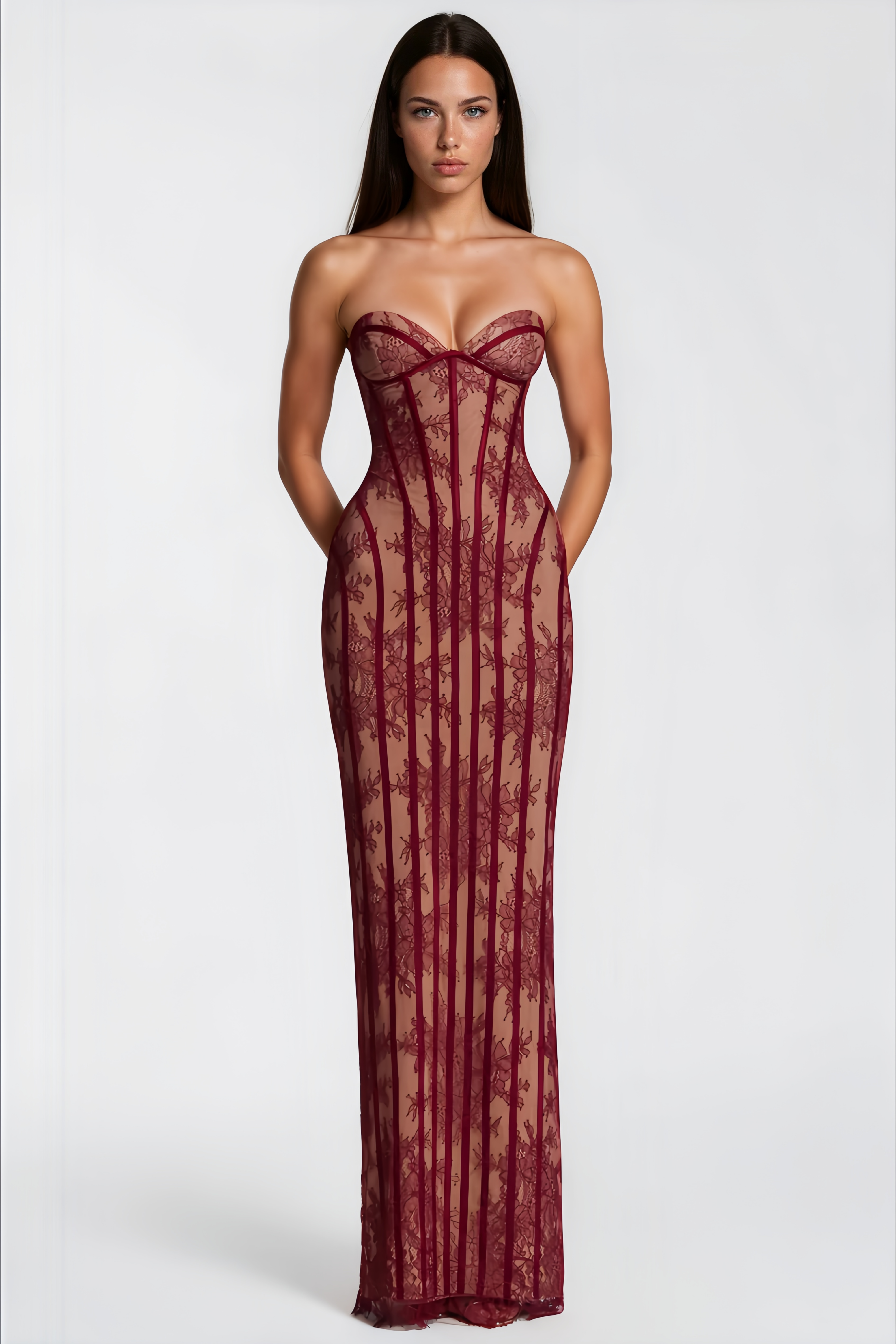 Burgundy strapless maxi dress featuring a nude lining with floral lace overlay and structured corset boning