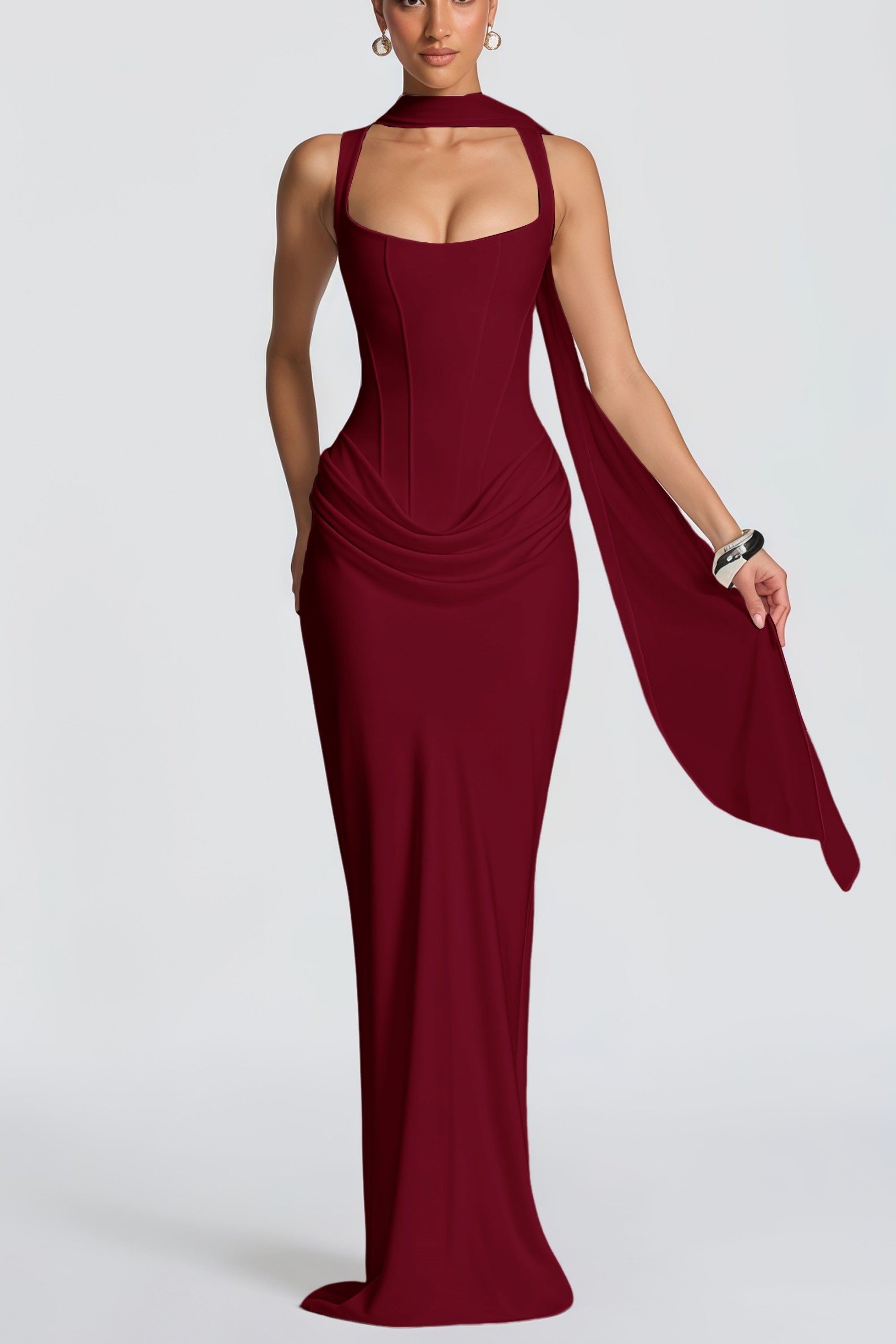 Burgundy floor-length gown with a corset-style bodice and draped hip detail