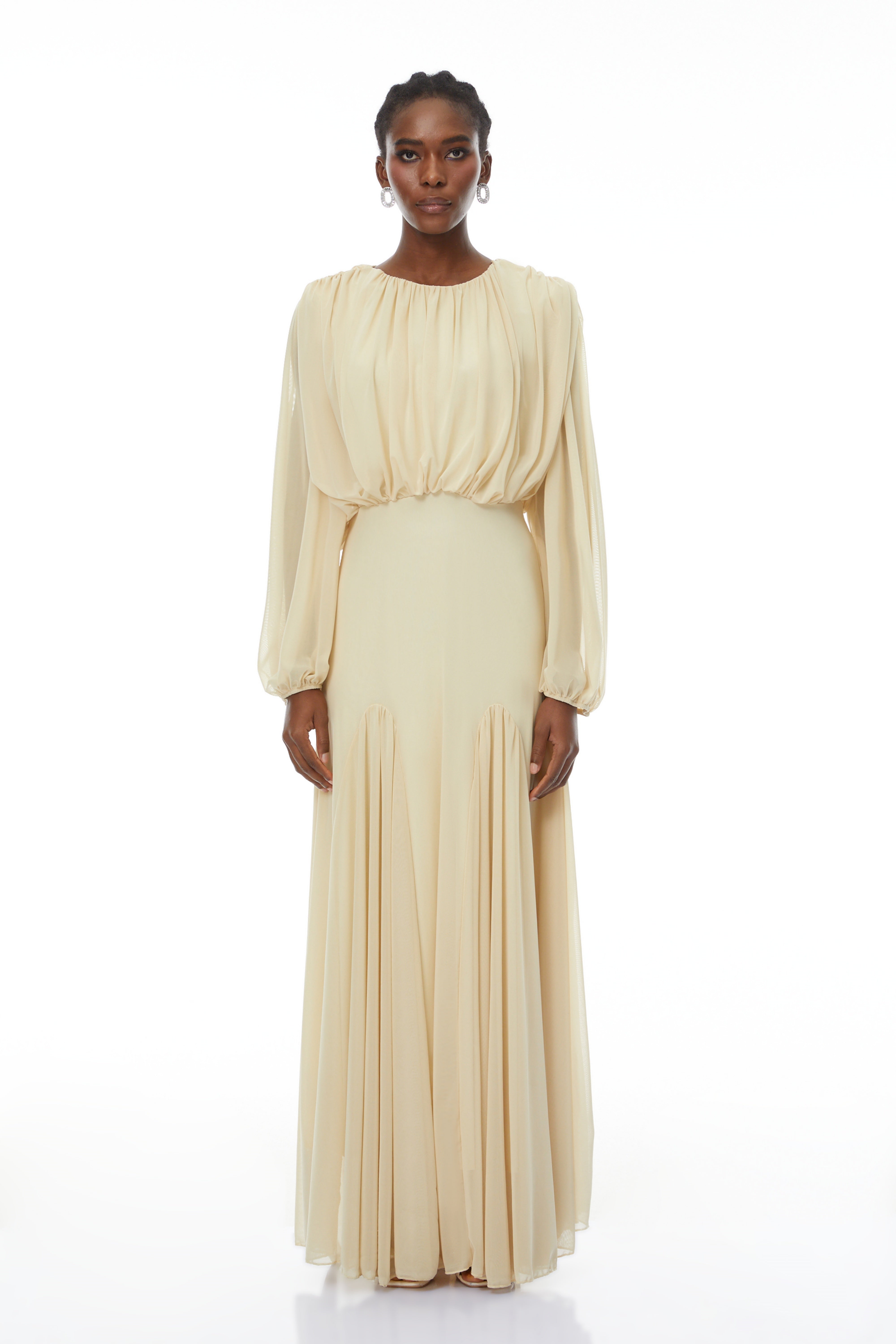 Pale yellow maxi dress with a ruched bodice, high round neckline, and long bishop sleeves