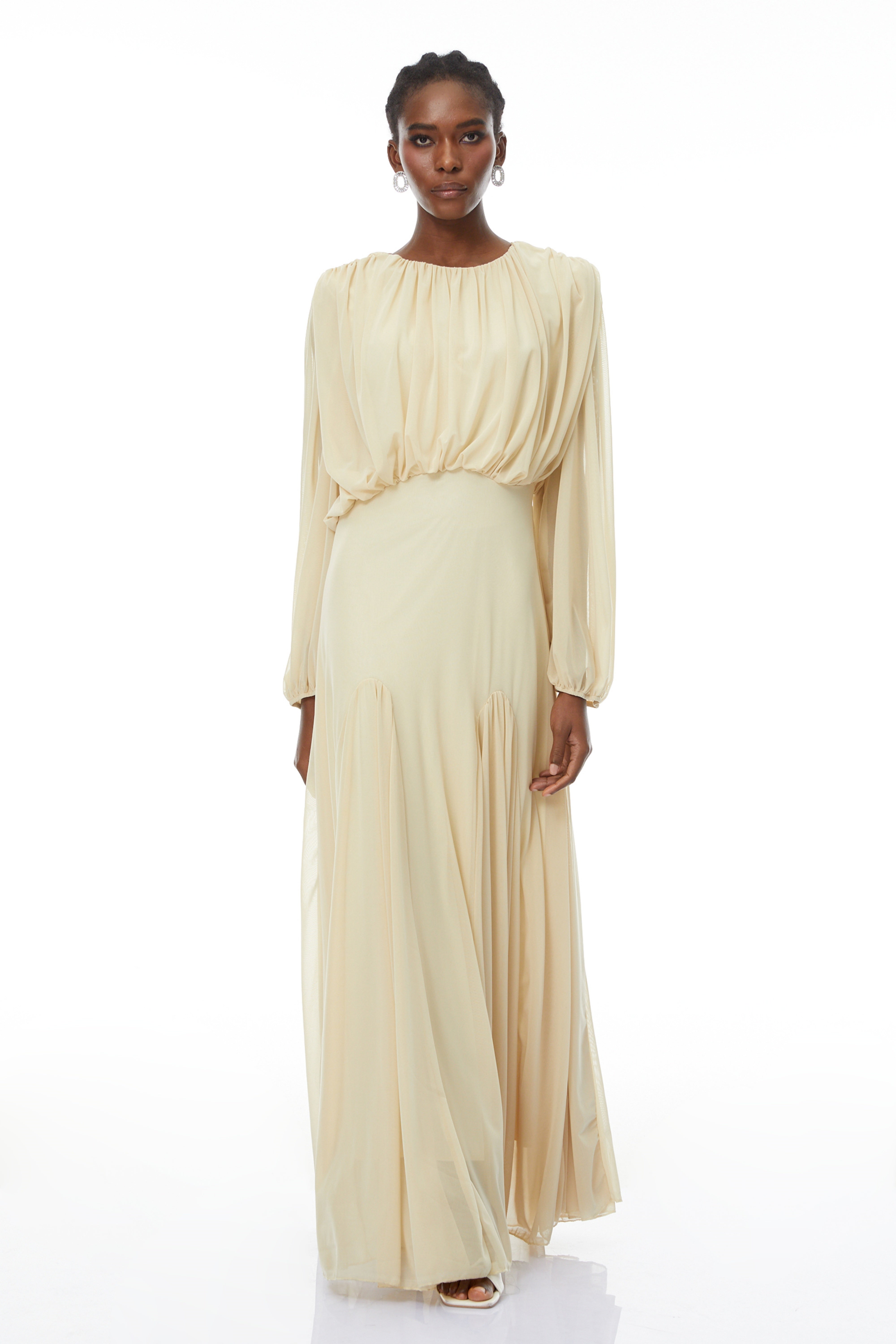 Pale yellow maxi dress with a ruched bodice, high round neckline, and long bishop sleeves