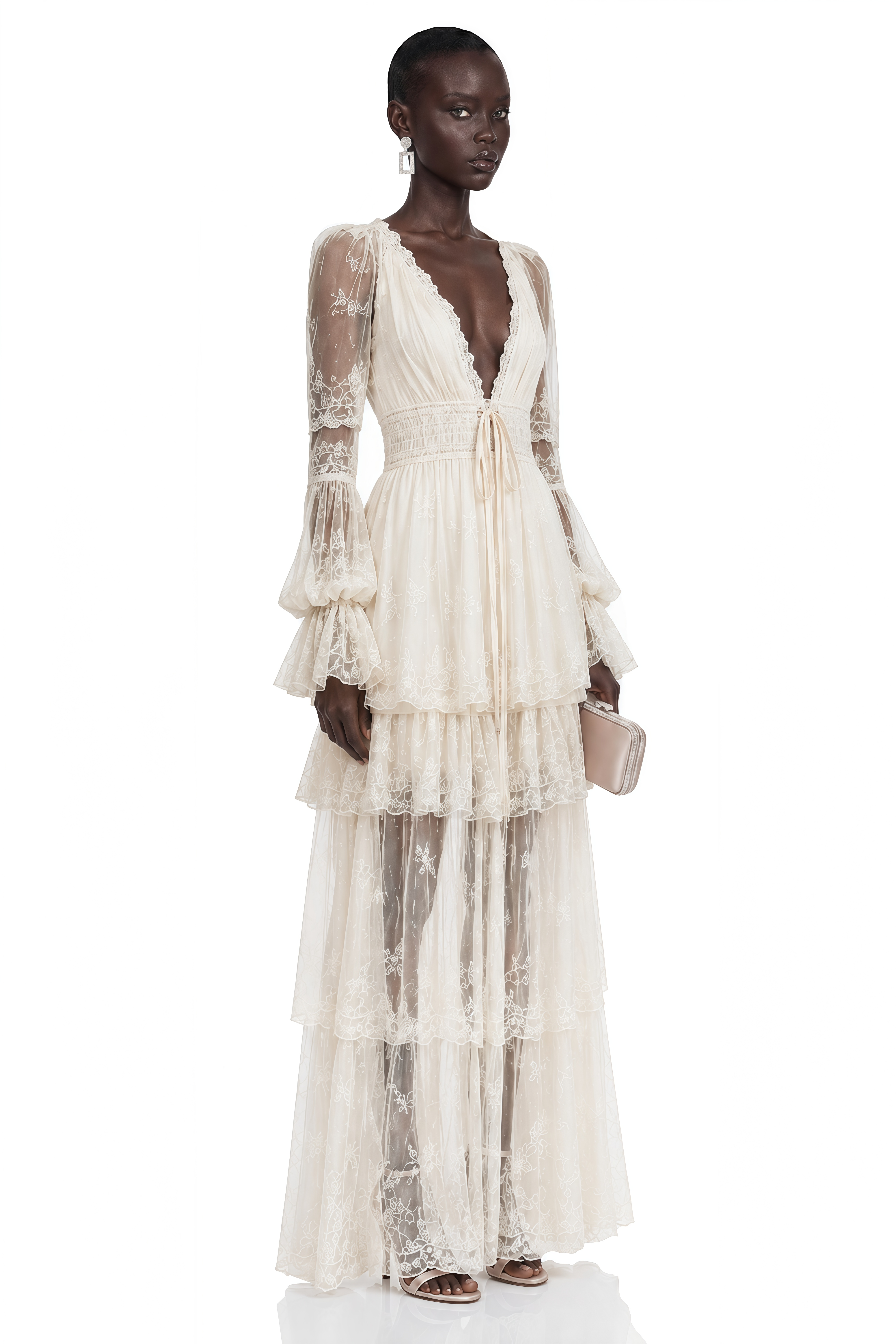 Ivory lace maxi dress with a deep V-neck, long sheer sleeves, and a tiered skirt