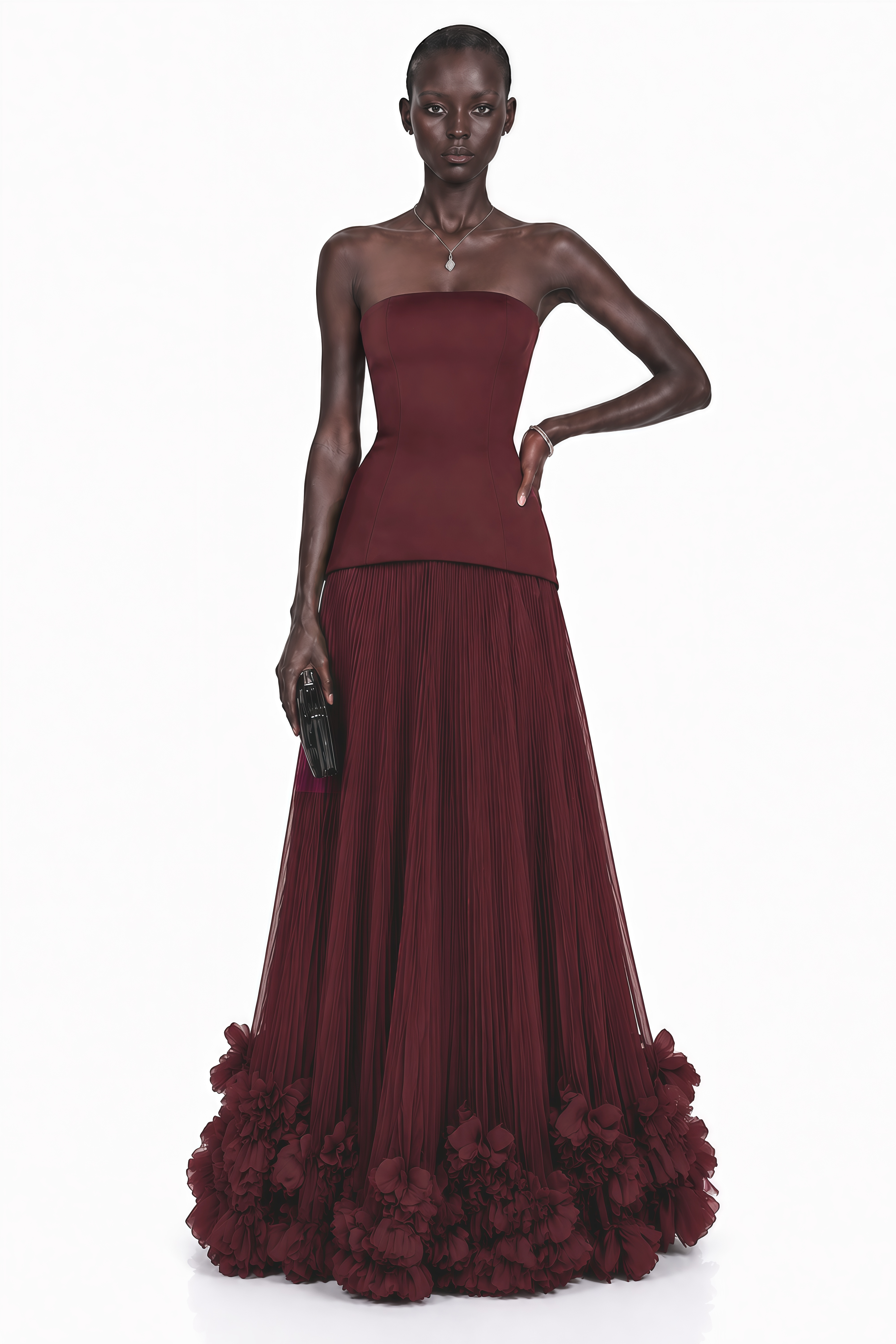 Burgundy strapless maxi dress with a drop-waist bodice and pleated tulle skirt featuring a ruffled hem