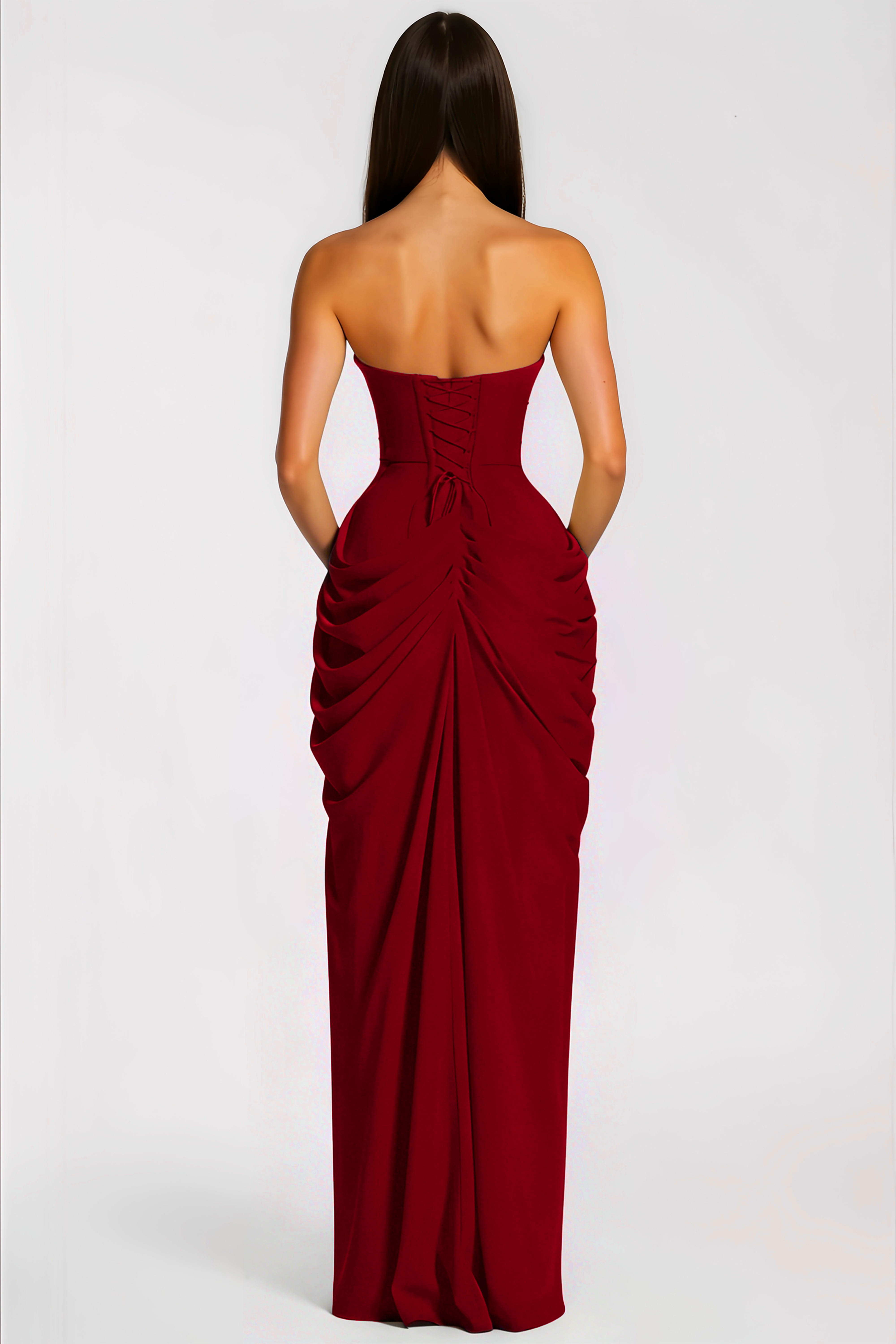 Red strapless maxi dress with a fitted bodice, a draped gathered hip, and a high thigh-high slit