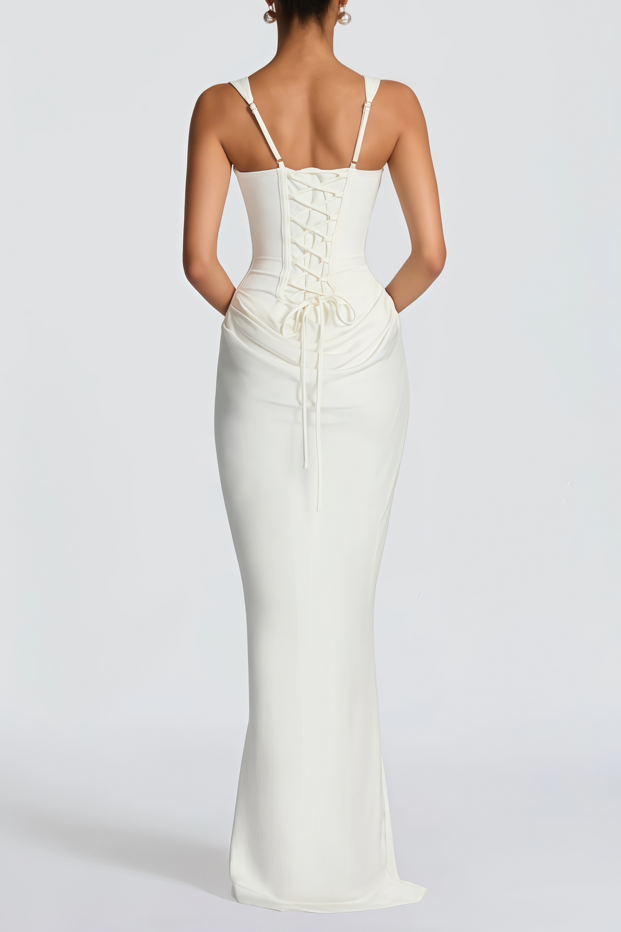 White sleeveless maxi dress with a corset-style bodice and draped hip detailing