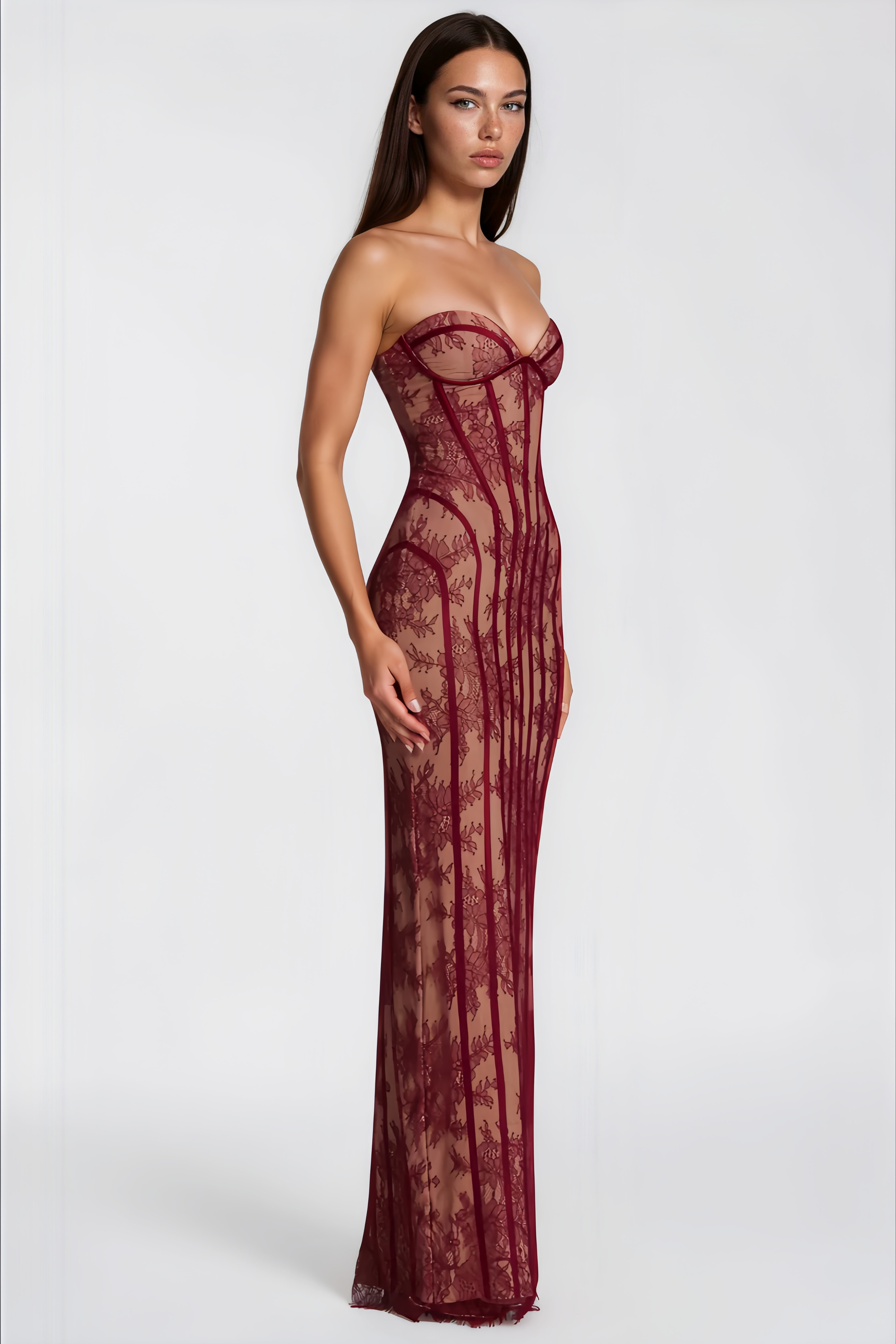 Burgundy strapless maxi dress featuring a nude lining with floral lace overlay and structured corset boning