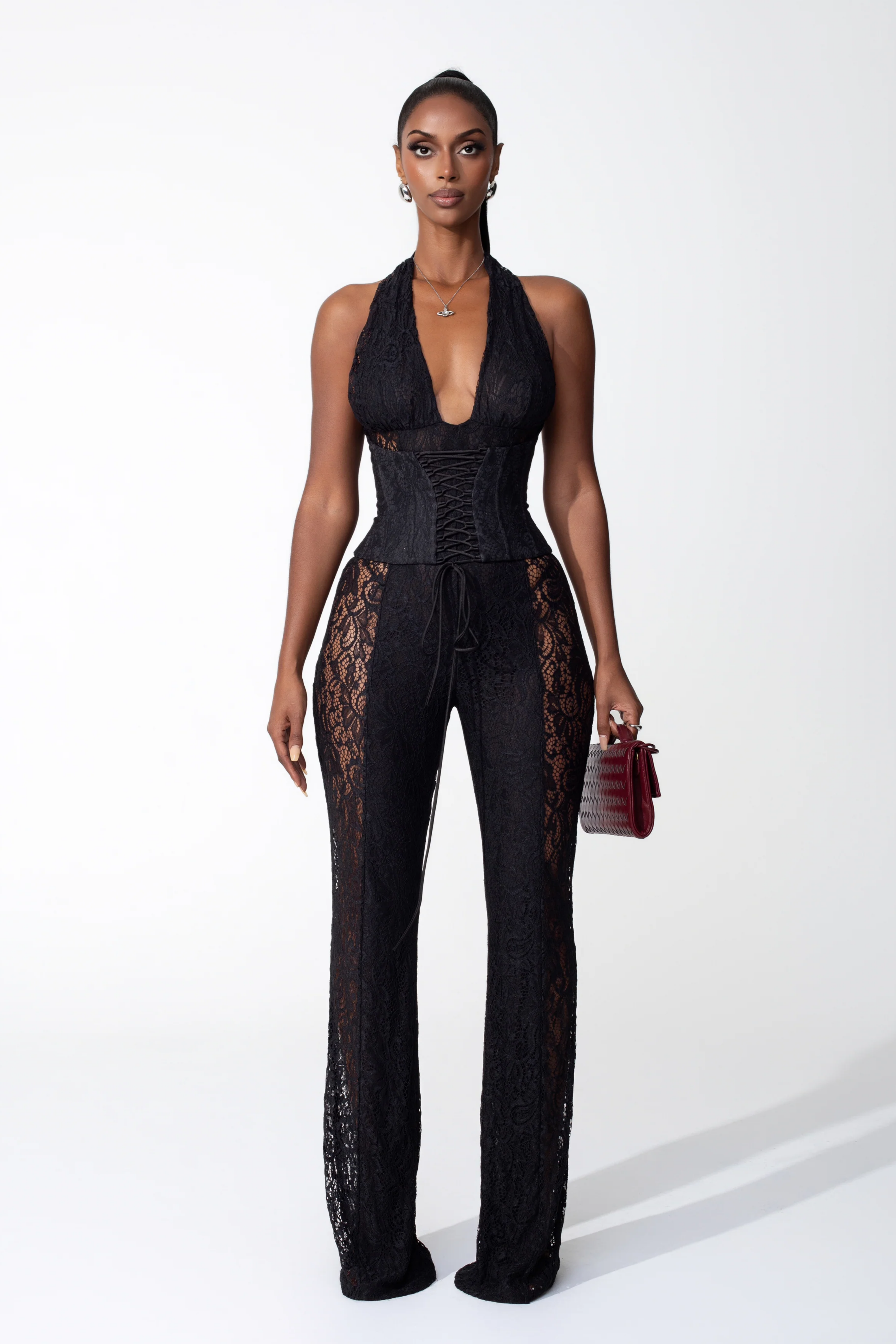 Lace halter jumpsuit with a corset-style lace-up bodice and flared legs